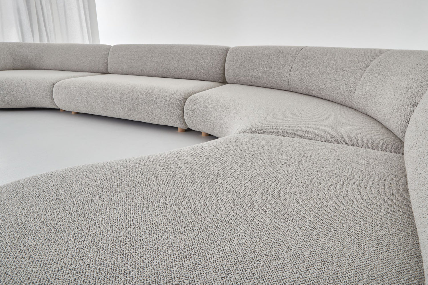 Eclipse expansive modular sofa setting with straight and curved sofa modules, viewed from the right hand side.