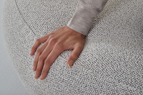 Woman's hand on curve of the Eclipse modular sofa