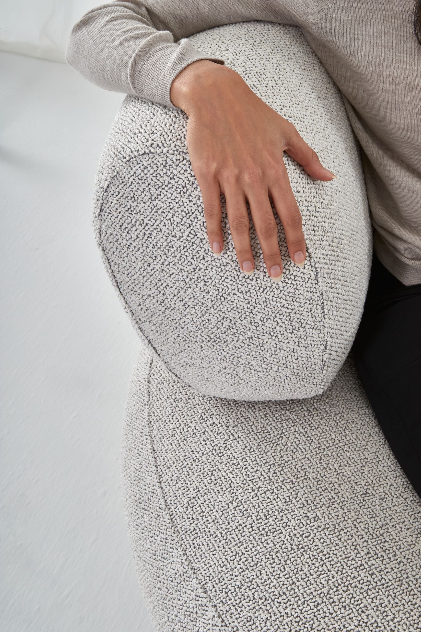 End of Eclipse sofa back-rest on left hand side end module with woman's hand.