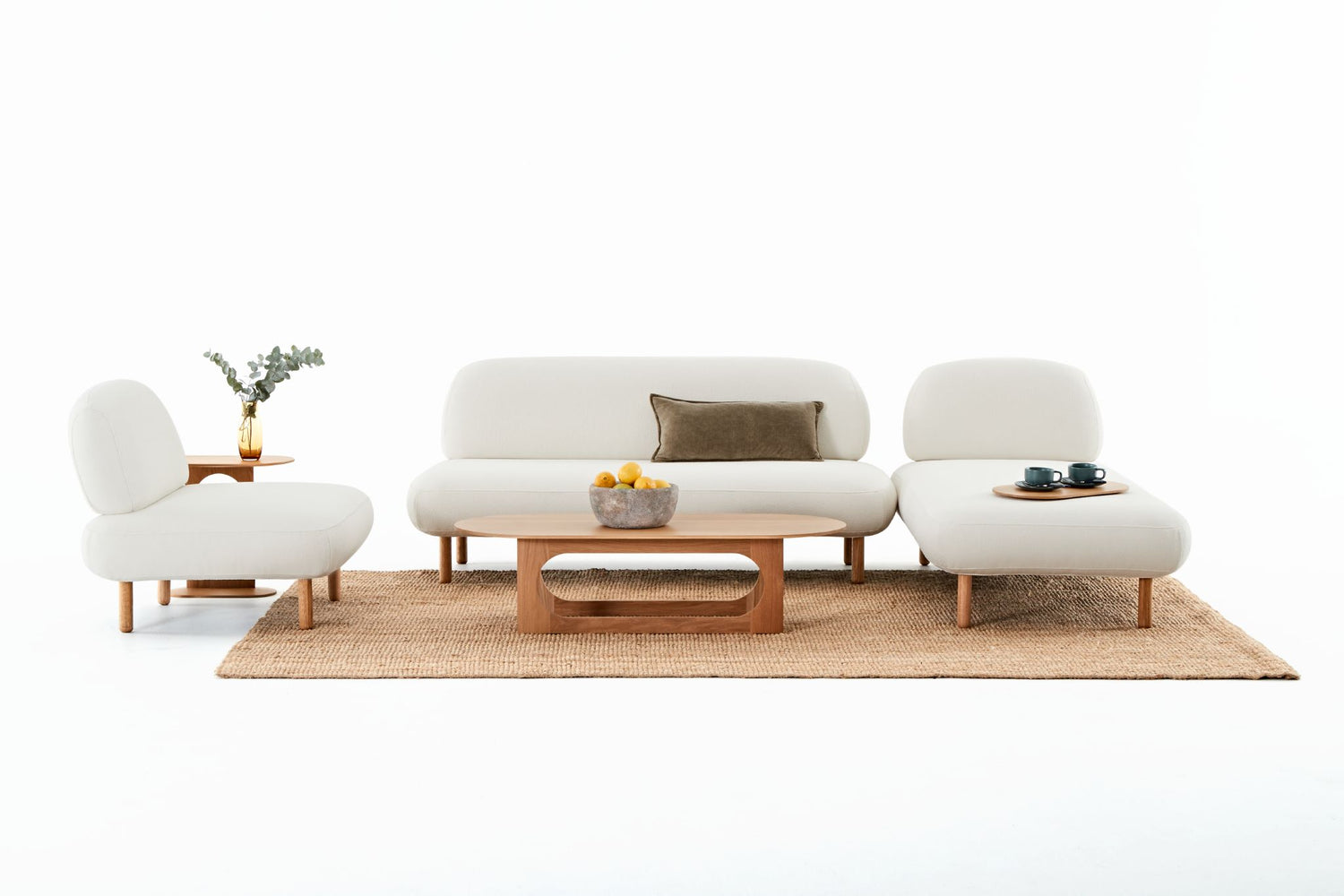 An Ethos sofa, chaise and chair combination showing the Ethos side and coffee tables and the tray table.