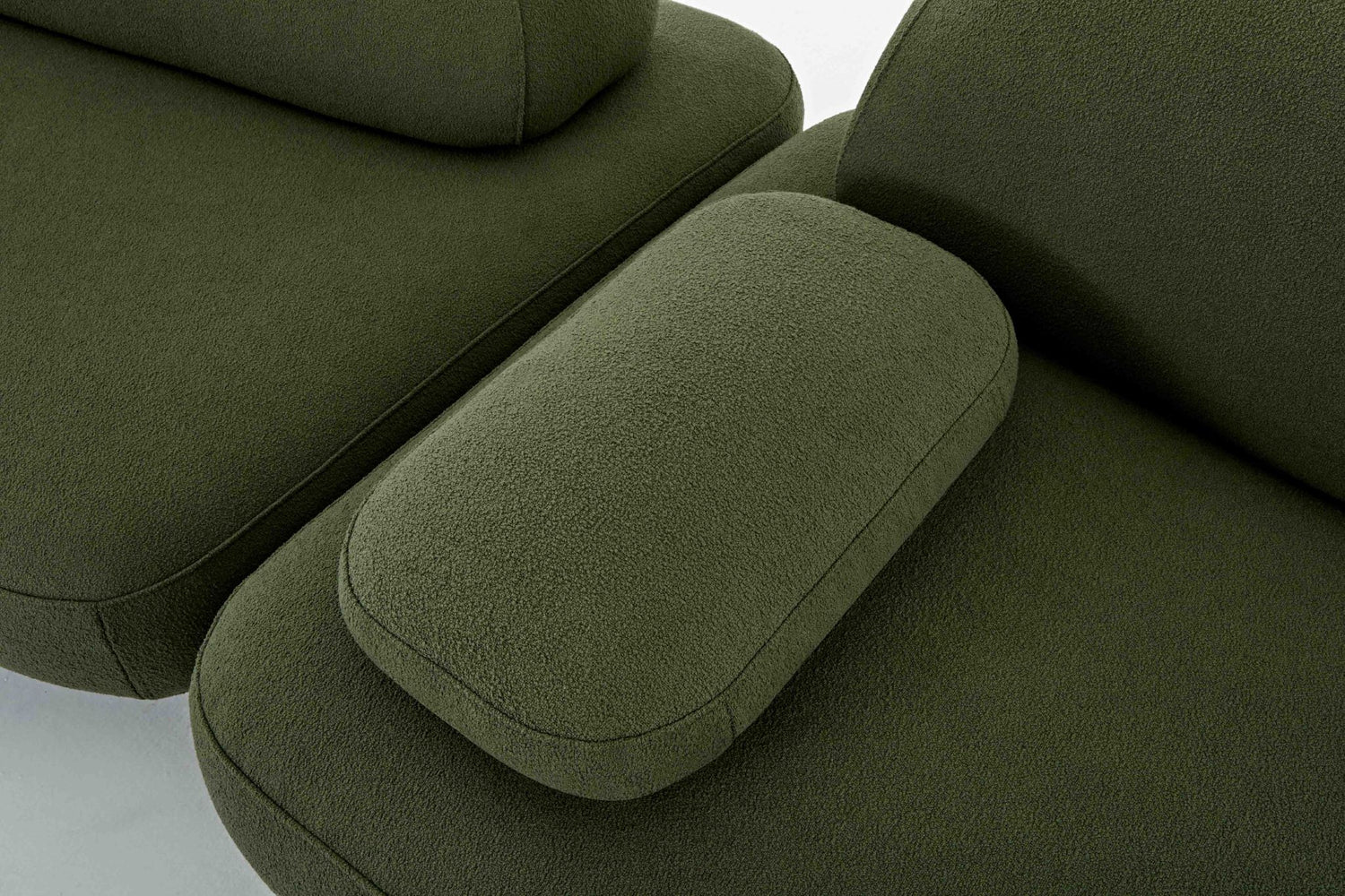Ethos Plus green modular sofa showing the moveable arm rest.