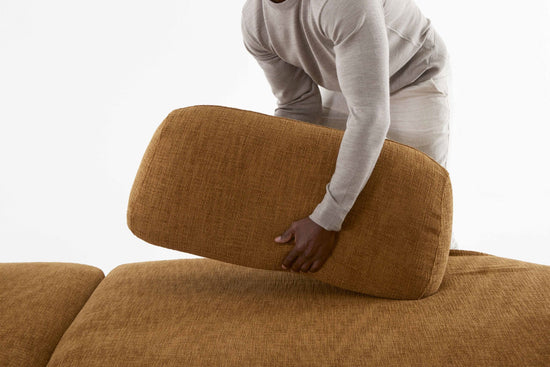 Man moving the Locus modular sofa moveable back rest