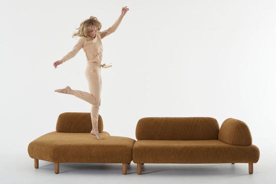 Locus sofa with woman jumping with outstretched arms