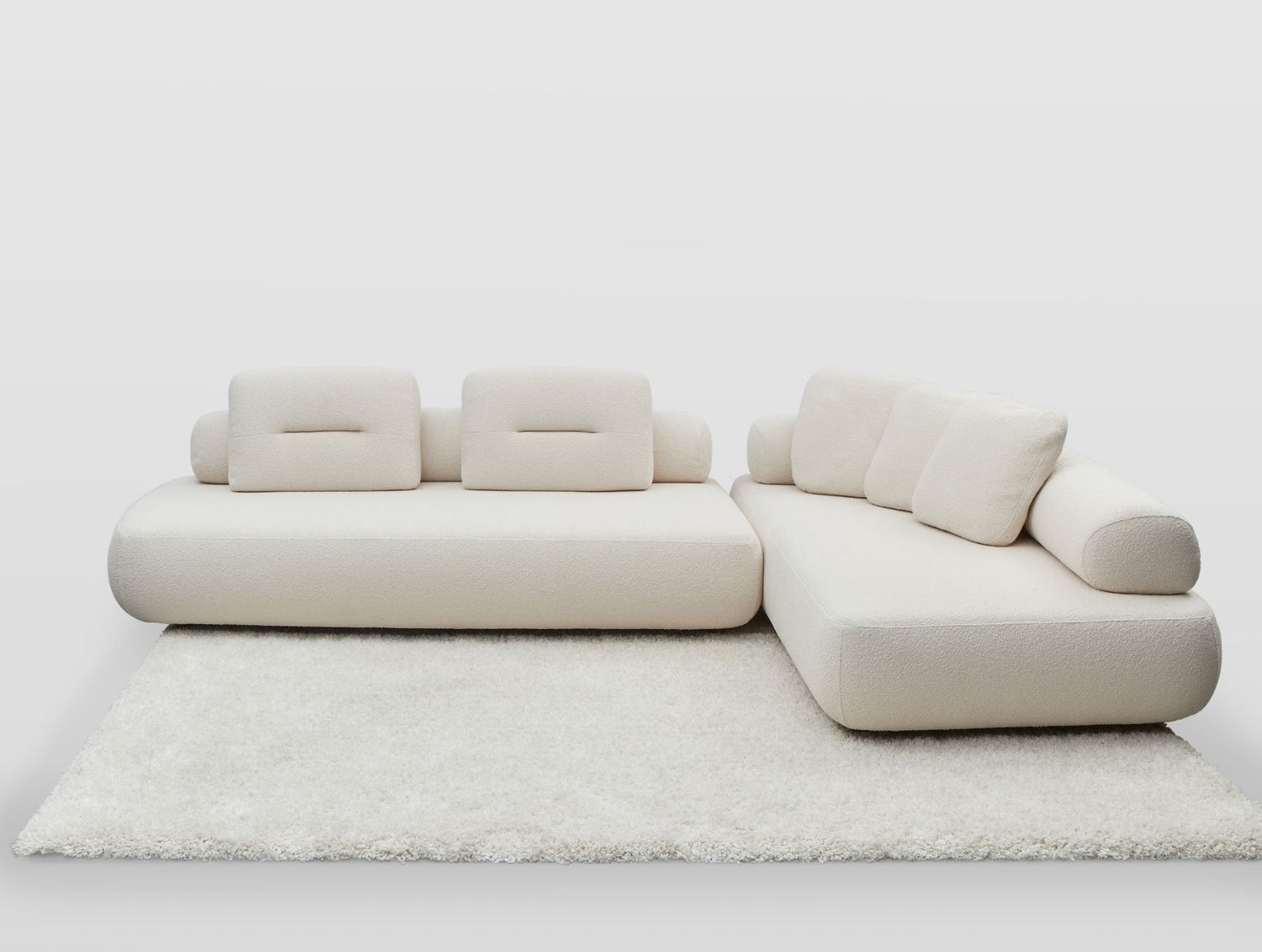 Newman sofa and chaise with back rolls swapped in white boucle