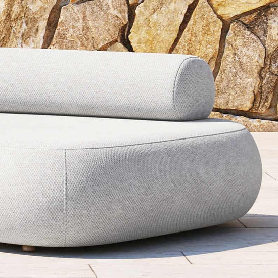 The curved end and moveable back roll of a Rolly Outdoor Sofa 