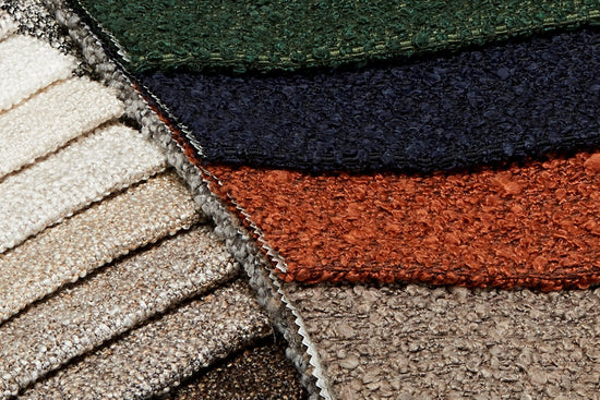 Fabric swatches showing green, blue, burnt orange and browns and taupes